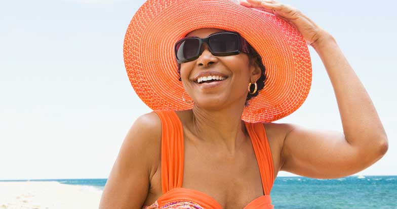 Woman wearing orange hat and sunglasses