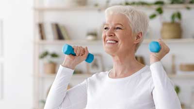 Mature adult woman lifting weights