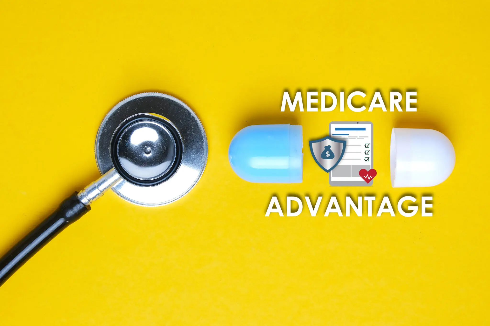 Stethoscope with fake pill capsule, letters spelling "medicare advantage "