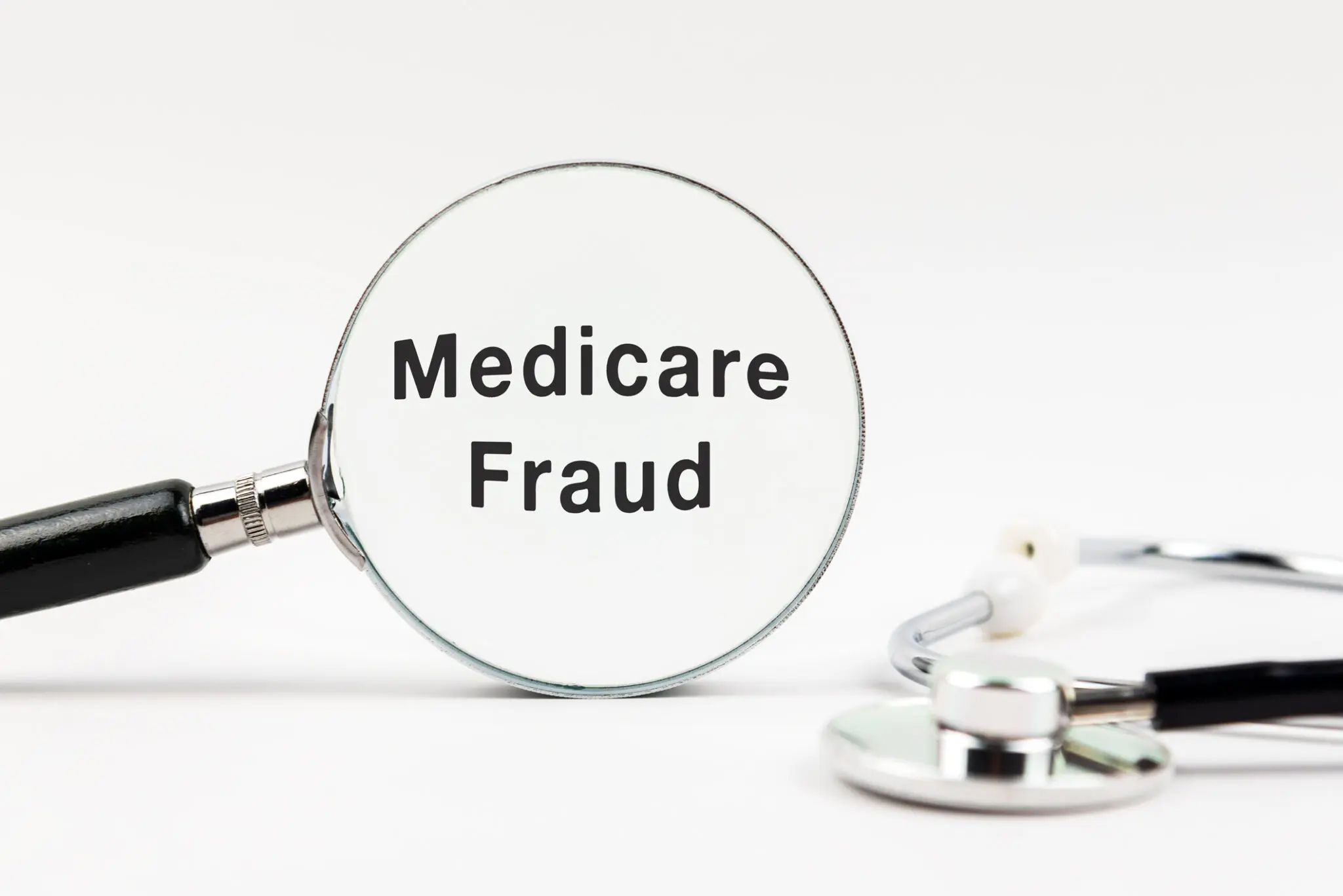 Magnifying lens focused on the word "Medicare Fraud"
